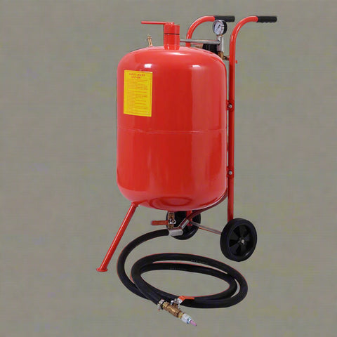 Red 20-gallon portable sandblasting tank with hose, wheels, and blasting accessories for rust and paint removal