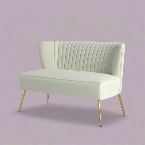 Fuchsia velvet loveseat with tufted back and gold legs in modern decor.
Ivory armless loveseat sofa with mid-century design in studio setup.
Tan velvet 2-seater with flared gold legs styled against a neutral wall.
Close-up of plush velvet texture and fluted backrest detail.
Color swatches displaying Fuchsia, Pink, Ivory, and Tan options.