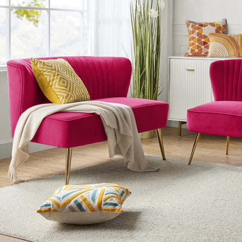 Fuchsia velvet loveseat with tufted back and gold legs in modern decor.
Ivory armless loveseat sofa with mid-century design in studio setup.
Tan velvet 2-seater with flared gold legs styled against a neutral wall.
Close-up of plush velvet texture and fluted backrest detail.
Color swatches displaying Fuchsia, Pink, Ivory, and Tan options.