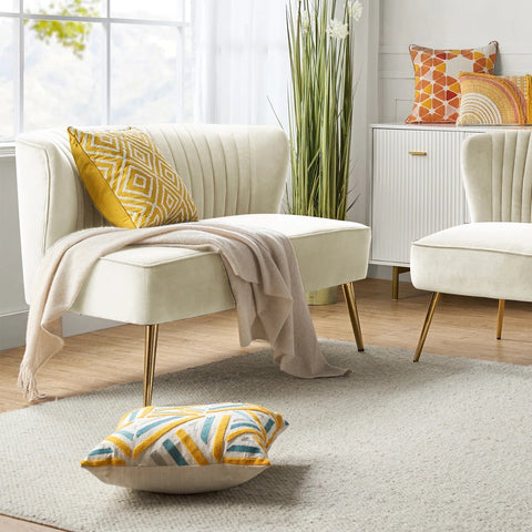 Fuchsia velvet loveseat with tufted back and gold legs in modern decor.
Ivory armless loveseat sofa with mid-century design in studio setup.
Tan velvet 2-seater with flared gold legs styled against a neutral wall.
Close-up of plush velvet texture and fluted backrest detail.
Color swatches displaying Fuchsia, Pink, Ivory, and Tan options.