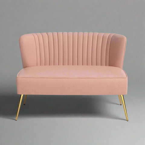 Fuchsia velvet loveseat with tufted back and gold legs in modern decor.
Ivory armless loveseat sofa with mid-century design in studio setup.
Tan velvet 2-seater with flared gold legs styled against a neutral wall.
Close-up of plush velvet texture and fluted backrest detail.
Color swatches displaying Fuchsia, Pink, Ivory, and Tan options.