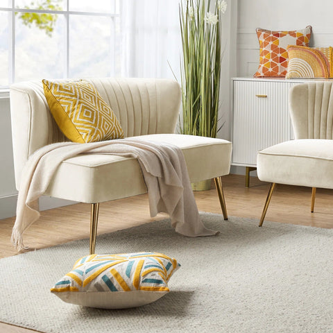 Fuchsia velvet loveseat with tufted back and gold legs in modern decor.
Ivory armless loveseat sofa with mid-century design in studio setup.
Tan velvet 2-seater with flared gold legs styled against a neutral wall.
Close-up of plush velvet texture and fluted backrest detail.
Color swatches displaying Fuchsia, Pink, Ivory, and Tan options.