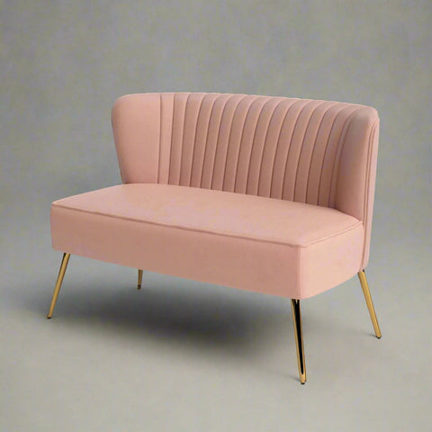 Fuchsia velvet loveseat with tufted back and gold legs in modern decor.
Ivory armless loveseat sofa with mid-century design in studio setup.
Tan velvet 2-seater with flared gold legs styled against a neutral wall.
Close-up of plush velvet texture and fluted backrest detail.
Color swatches displaying Fuchsia, Pink, Ivory, and Tan options.