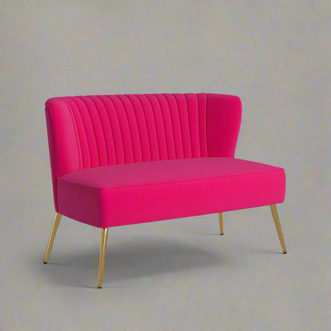 Fuchsia velvet loveseat with tufted back and gold legs in modern decor.
Ivory armless loveseat sofa with mid-century design in studio setup.
Tan velvet 2-seater with flared gold legs styled against a neutral wall.
Close-up of plush velvet texture and fluted backrest detail.
Color swatches displaying Fuchsia, Pink, Ivory, and Tan options.