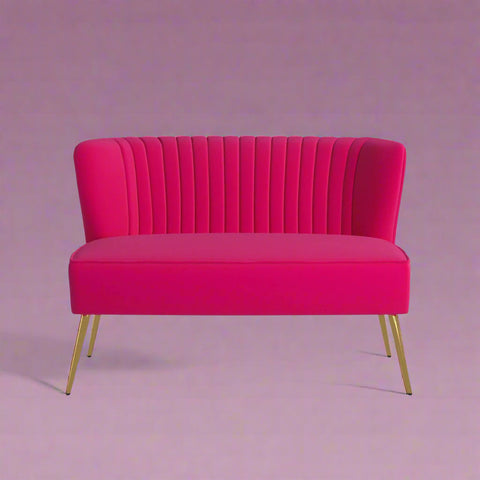 Fuchsia velvet loveseat with tufted back and gold legs in modern decor.
Ivory armless loveseat sofa with mid-century design in studio setup.
Tan velvet 2-seater with flared gold legs styled against a neutral wall.
Close-up of plush velvet texture and fluted backrest detail.
Color swatches displaying Fuchsia, Pink, Ivory, and Tan options.