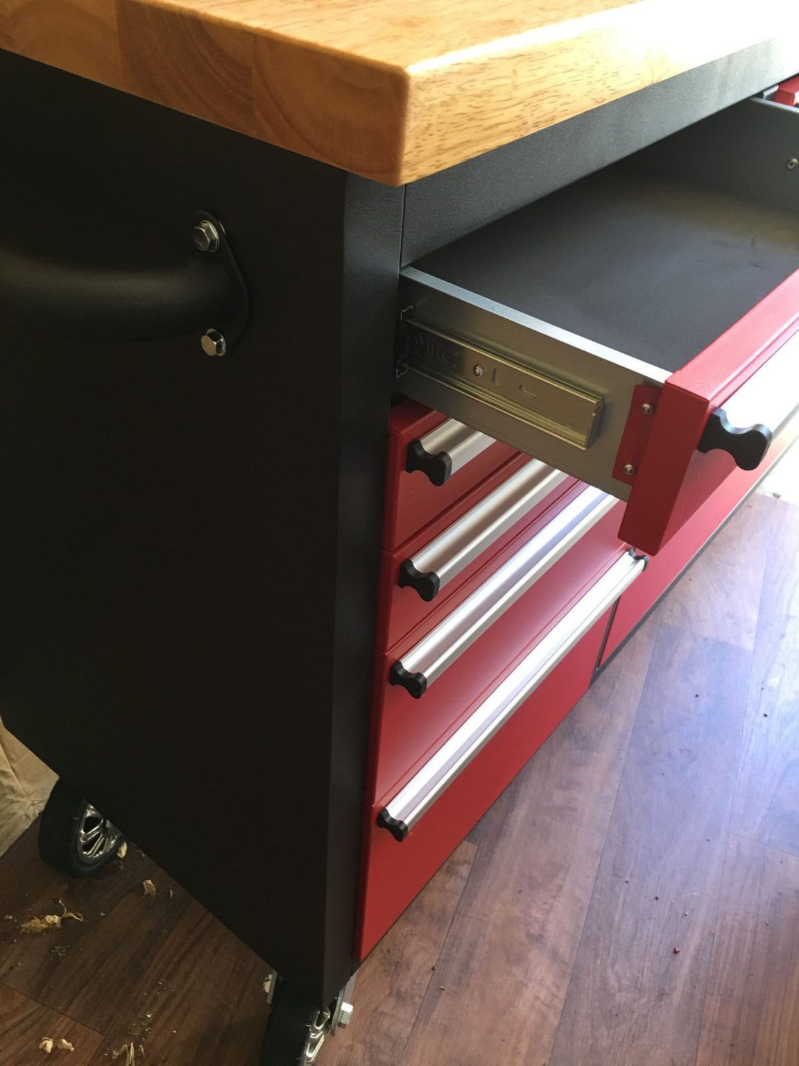 Red 17-drawer rolling tool chest with workbench top
Heavy-duty garage tool cabinet with rubberwood work surface
Industrial mobile workbench with 15 smooth-glide drawers
Garage storage cabinet with aluminum handles and locking system