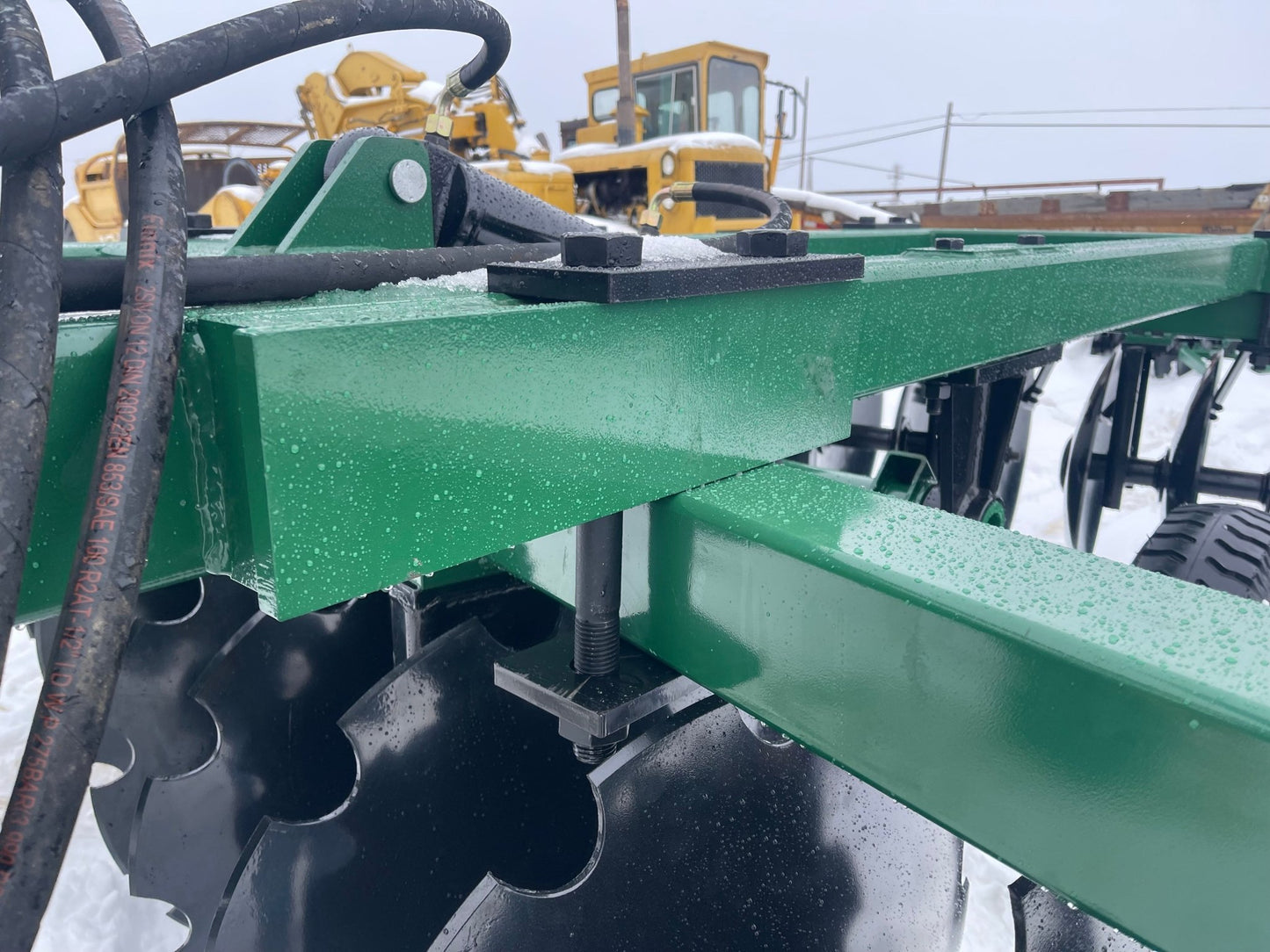 10 FT Hydraulic Offset Tractor Disc Harrow in field setup
Side view of 10-foot disc harrow with 28 manganese steel blades
Rear blade configuration of hydraulic disc harrow
Top view showing hydraulic tubing and disc spacing
Offset disc harrow mounted on green tractor for field work