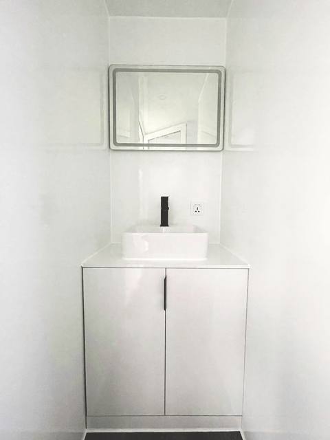 Expandable glass container house with black frame and white kitchen interior
20ft high cube glass container house on an outdoor plot
Modern prefab modular container home with large glass walls
Inside view of the container house kitchen and bathroom setup
portable luxury container home with plumbing and wiring