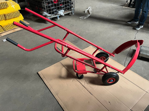 Red tire trolley cart with pneumatic wheels in garage
Heavy-duty tire dolly lifting tire set, ergonomic grip detail, welded frame close-up, tire stack in transit