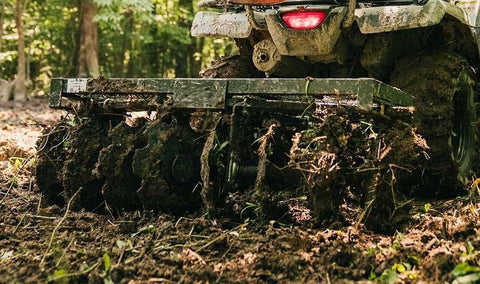 4 FT disc harrow with 8 notched discs – ATV and lawn tractor attachment
Pull-behind disc harrow implement with adjustable disc gangs
ATV towing black disc tiller through field for food plot preparation