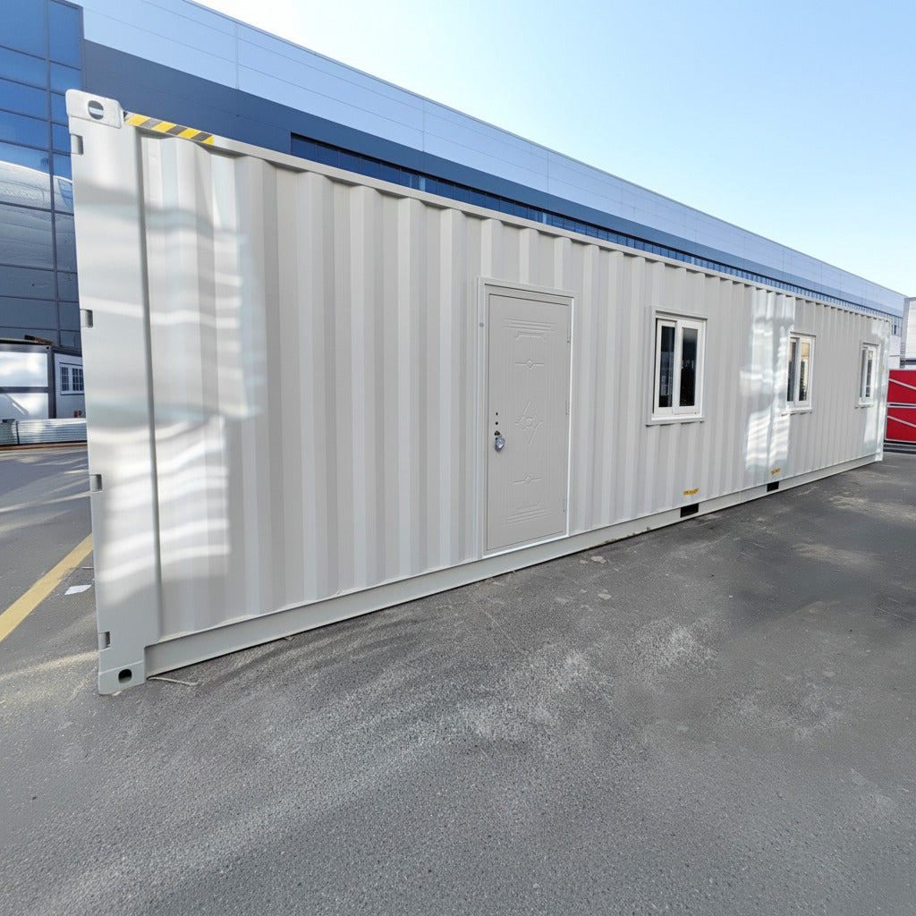 Exterior view of 40 FT insulated container office cabin
Interior layout showing vinyl flooring and workstations
TPS insulated walls and faux leather trim details
Plumbing and water system built into mobile cabin
Rear angle showing door and window design