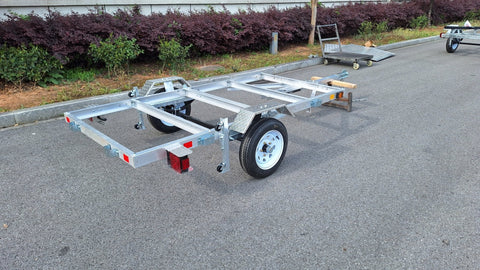 "4x8 folding aluminum utility trailer with built-in casters"
"Space-saving lightweight trailer for small vehicle hauling"
"Compact aluminum trailer folded vertically for storage"