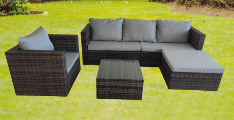 "5-piece L-shaped outdoor sectional with cushions and table"
"Modular patio furniture set in backyard setting"
"Gray cushioned patio sofa with glass coffee table"
"Weatherproof outdoor wicker sectional for patio"
"Durable resin wicker outdoor furniture with ottomans"