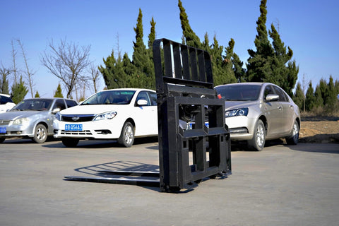 Side view of 5000 lb side shift pallet forks for skid steer
Heavy-duty hydraulic pallet fork with side shift mechanism
Pallet fork attachment mounted on forklift outdoors
Black steel frame skid steer pallet forks with side shift
Industrial pallet forks for warehouse and yard use