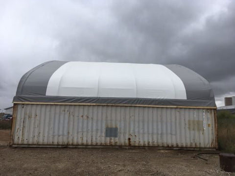 50x80 ft all-white PVC double truss fabric shelter installed over shipping containers β heavy-duty industrial storage building