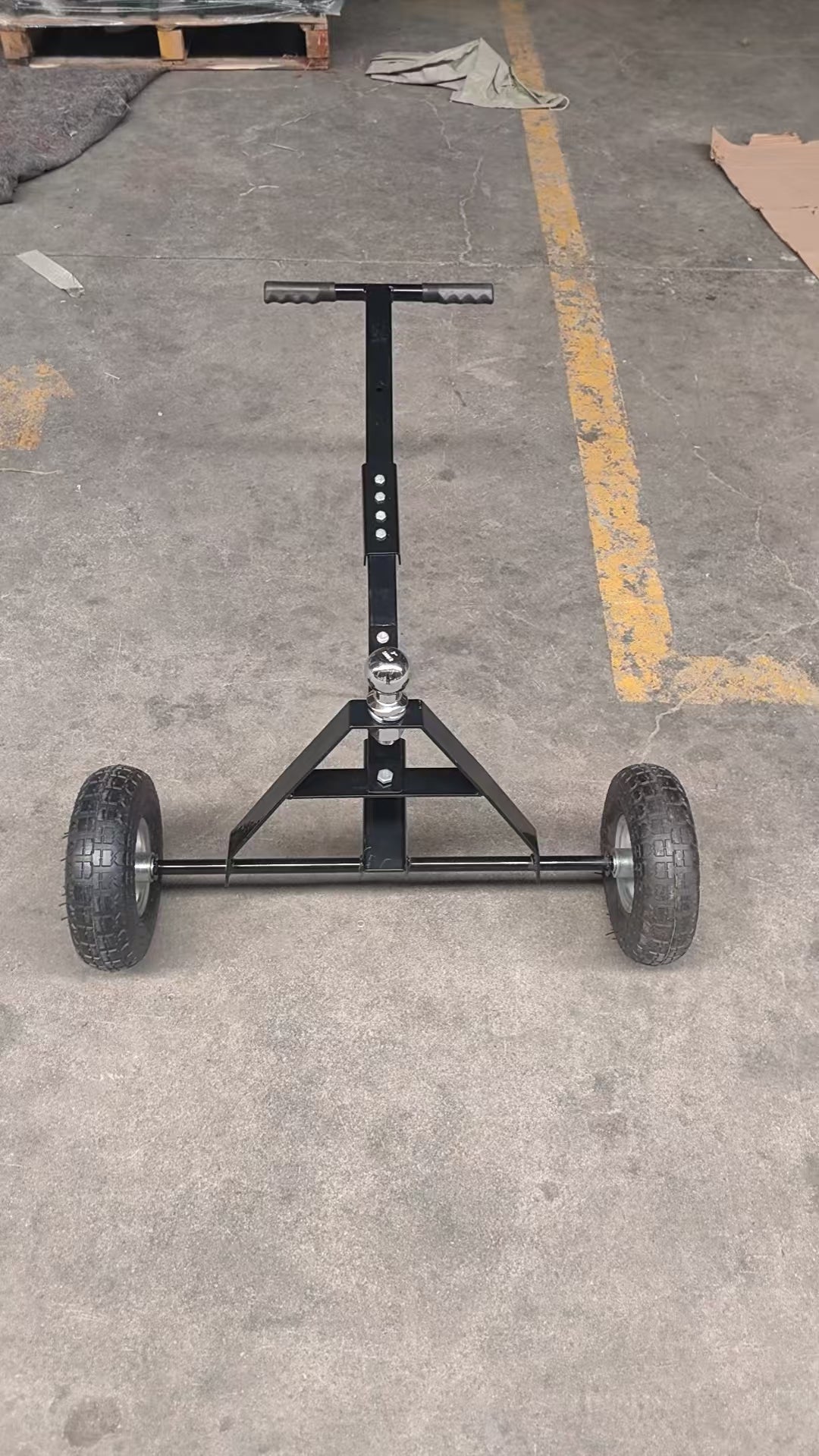 Manual hitch dolly TD600 with trailer hookup on pavement
Close-up of TD600 trailer dolly wheels and hitch ball
Side view of trailer dolly being manually pushed
Hand-push trailer dolly on gravel driveway