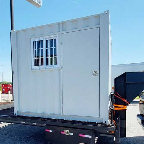 Gray 7FT steel office container with side door and windows
Interior view of 12FT jobsite office sea container
Office container unit with swing door and locking system
Plywood flooring inside portable office container
Security window with locking bar on steel sea container