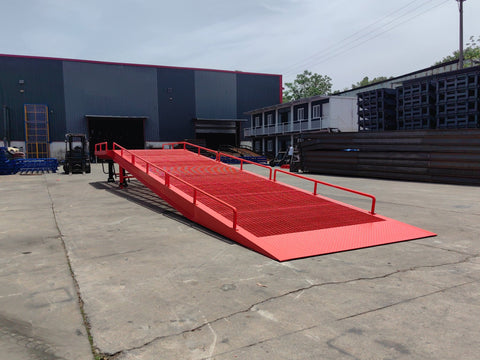 Heavy-duty loading dock ramp with red grating on asphalt yard
Forklift-compatible yard ramp side view with guardrails
Industrial dock ramp base plate and wheels
Side profile of 8 ft wide portable dock ramp
Ramp surface with serrated anti-slip steel close-up