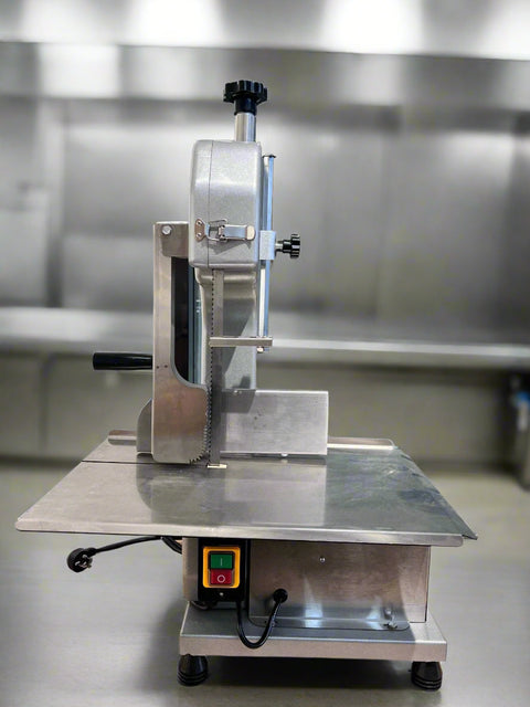 Full front view of a commercial frozen meat and bone saw machine
Side angle of a stainless steel cutting saw in a commercial kitchen
Bone saw machine in use, cutting frozen meat
Operator slicing frozen beef bones with an electric meat saw
Commercial food processing bone cutting equipment in operation
Close-up of adjustable blade on automatic bone saw
