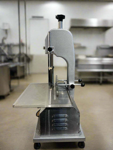Full front view of a commercial frozen meat and bone saw machine
Side angle of a stainless steel cutting saw in a commercial kitchen
Bone saw machine in use, cutting frozen meat
Operator slicing frozen beef bones with an electric meat saw
Commercial food processing bone cutting equipment in operation
Close-up of adjustable blade on automatic bone saw