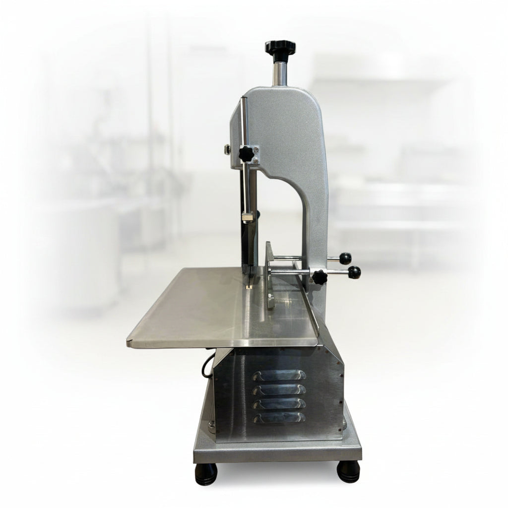 Full front view of a commercial frozen meat and bone saw machine
Side angle of a stainless steel cutting saw in a commercial kitchen
Bone saw machine in use, cutting frozen meat
Operator slicing frozen beef bones with an electric meat saw
Commercial food processing bone cutting equipment in operation
Close-up of adjustable blade on automatic bone saw