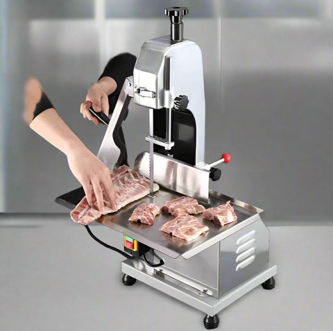Full front view of a commercial frozen meat and bone saw machine
Side angle of a stainless steel cutting saw in a commercial kitchen
Bone saw machine in use, cutting frozen meat
Operator slicing frozen beef bones with an electric meat saw
Commercial food processing bone cutting equipment in operation
Close-up of adjustable blade on automatic bone saw