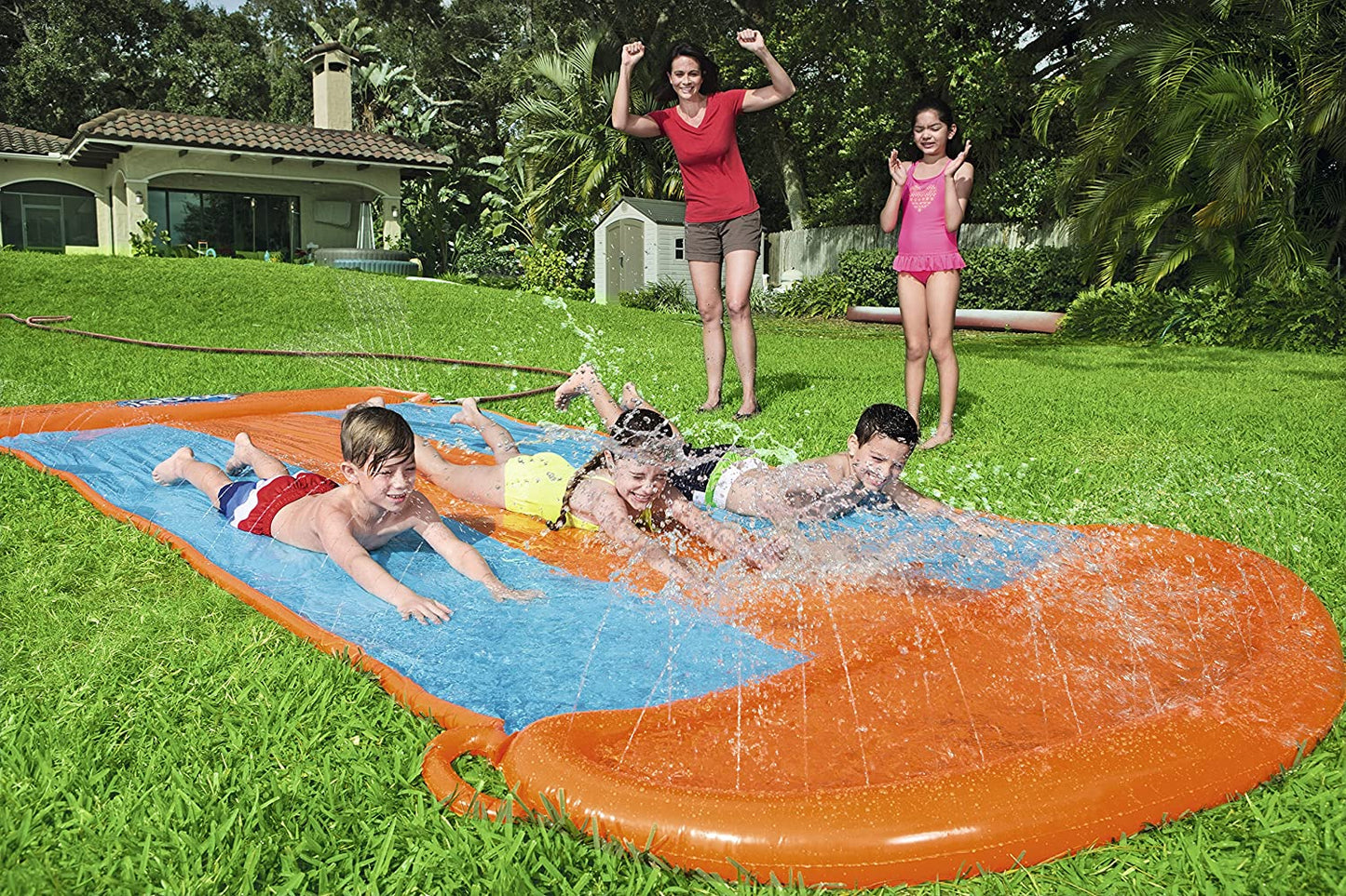 Kids racing on Bestway triple water slide
Three-lane orange slip and slide in backyard
Built-in sprinklers on Bestway water slide
Bestway Aqua Ramp start with splash effect
Inflatable water slide for kids and families