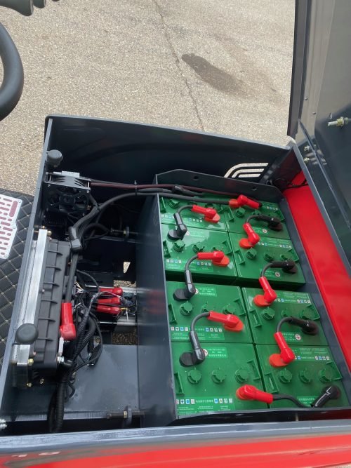 CanLift 4000 LBS orange electric forklift with 118” lift and 42” forks
Profile shot of forklift with raised mast and battery housing
Rear view of forklift with control panel and operator seat
42” heavy-duty forks and solid tires
Close-up of fork shifting mechanism