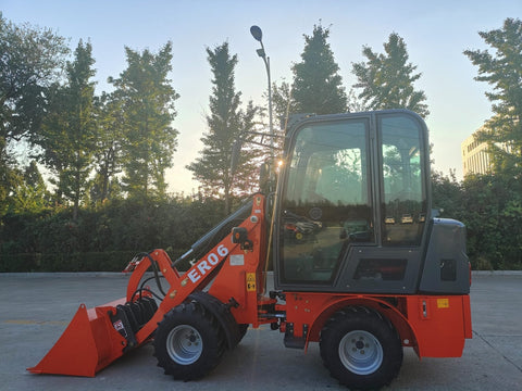 CanLift Mini Wheel Loader with Kubota D1703 engine
Orange and gray wheel loader with enclosed cabin
Compact loader with quick hitch and bucket
Mini loader for snow removal and landscaping
Hydrostatic drive mini loader with joystick control