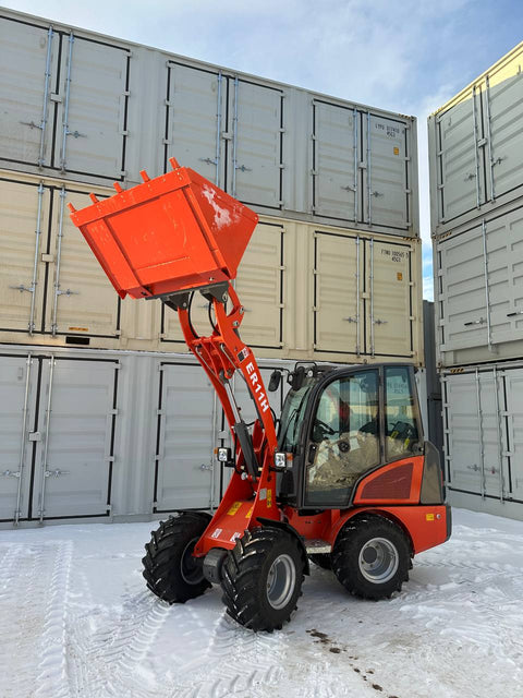CanLift Mini Wheel Loader with Kubota D1703 engine, orange color – front view
Side view of CanLift compact loader with closed cabin and bucket raised
CanLift mini loader in operation – orange machine on construction site