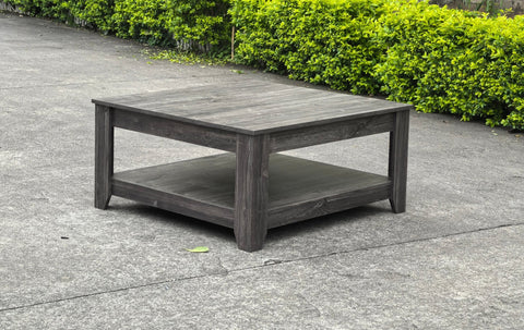 Dark gray oak square coffee table styled in a modern living room
Close-up of woodgrain texture and lower shelf
Angled view of the full table with storage items
The coffee table is placed with decorative accessories
Dark oak coffee table with books and a remote on the shelf