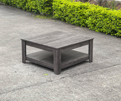 Dark gray oak square coffee table styled in a modern living room
Close-up of woodgrain texture and lower shelf
Angled view of the full table with storage items
The coffee table is placed with decorative accessories
Dark oak coffee table with books and a remote on the shelf