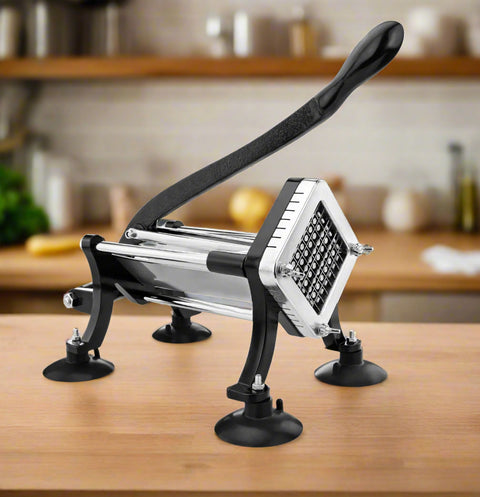 Deluxe stainless steel French fry cutter with suction feet on wood countertop