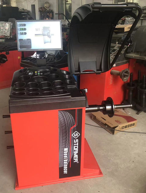Deluxe red wheel balancer machine with HD LCD screen
Tire balancing machine in auto shop with digital interface
Close-up of WB300A wheel balancer control screen
Precision wheel balancing tool for auto repair garages