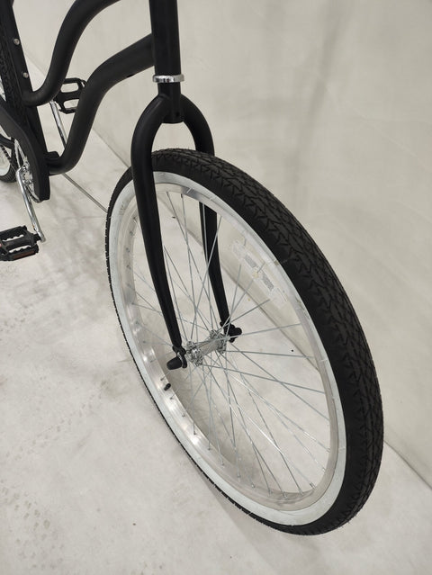Side view of Deviant 26" beach cruiser bicycle in matte black
Close-up of comfort seat and handlebar grips
Rear coaster brake and single-speed drivetrain
Full assembled view of the Deviant black cruiser bike
Cruiser bike parked on a path at sunset
