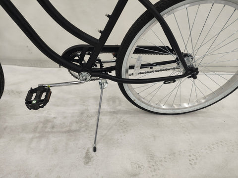 Side view of Deviant 26" beach cruiser bicycle in matte black
Close-up of comfort seat and handlebar grips
Rear coaster brake and single-speed drivetrain
Full assembled view of the Deviant black cruiser bike
Cruiser bike parked on a path at sunset