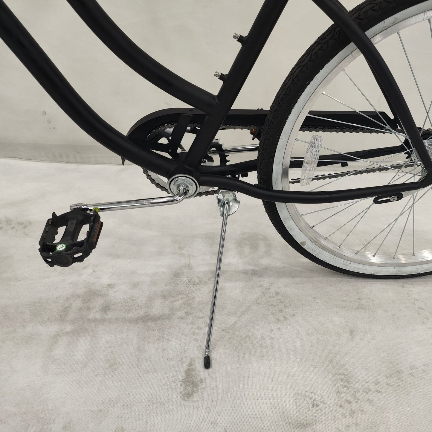 Side view of Deviant 26" beach cruiser bicycle in matte black
Close-up of comfort seat and handlebar grips
Rear coaster brake and single-speed drivetrain
Full assembled view of the Deviant black cruiser bike
Cruiser bike parked on a path at sunset