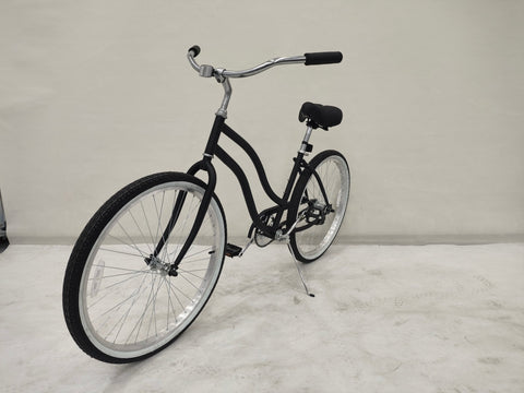 Side view of Deviant 26" beach cruiser bicycle in matte black
Close-up of comfort seat and handlebar grips
Rear coaster brake and single-speed drivetrain
Full assembled view of the Deviant black cruiser bike
Cruiser bike parked on a path at sunset