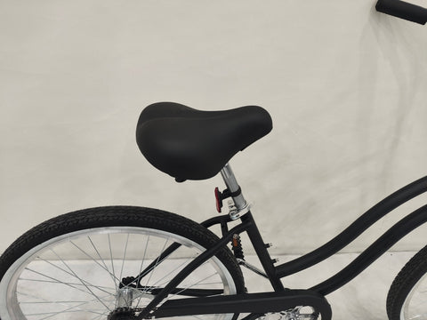 Side view of Deviant 26" beach cruiser bicycle in matte black
Close-up of comfort seat and handlebar grips
Rear coaster brake and single-speed drivetrain
Full assembled view of the Deviant black cruiser bike
Cruiser bike parked on a path at sunset