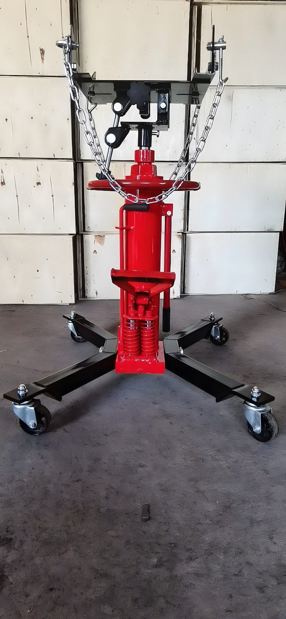 "Double piston 2-stage hydraulic transmission jack with red steel frame"
"1320 lb telescopic transmission lift jack for vehicle maintenance"
"Heavy-duty transmission jack with foot pump and swivel casters"