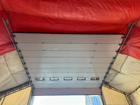 White insulated electric overhead garage door installed in shop
Heavy-duty motorized overhead garage door with steel frame
Electric garage door kit with insulation for industrial buildings
Overhead sectional garage door installed on warehouse