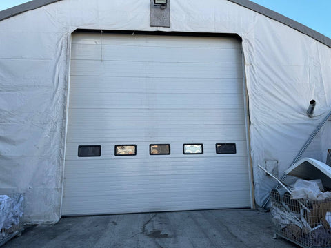 White insulated electric overhead garage door installed in shop
Heavy-duty motorized overhead garage door with steel frame
Electric garage door kit with insulation for industrial buildings
Overhead sectional garage door installed on warehouse