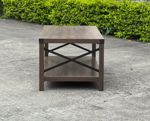 Gray wash rustic coffee table with metal X-frame in the living room
Front view of the coffee table showing shelf storage
Side angle showing gray tabletop and open shelf
Coffee table outdoors with accessories
Detail of gray wash wood and black frame