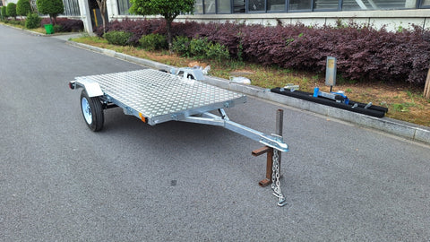 Heavy-duty galvanized 4x8 folding utility trailer with checker plate deck and road-ready tires
