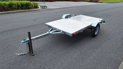 Heavy-duty galvanized 4x8 folding utility trailer with checker plate deck and road-ready tires