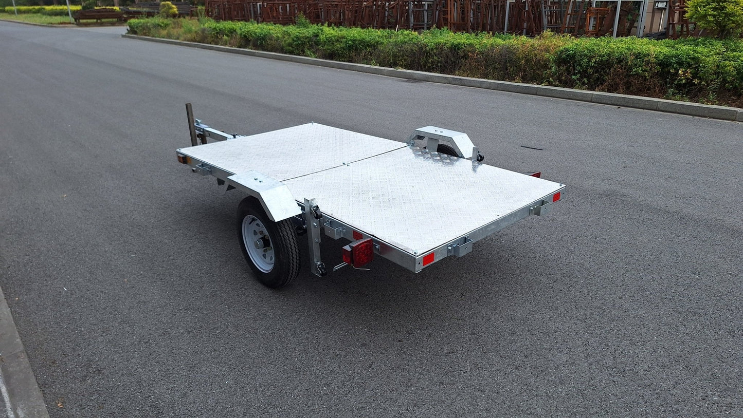 Heavy-duty galvanized 4x8 folding utility trailer with checker plate deck and road-ready tires