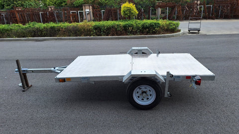Heavy-duty galvanized 4x8 folding utility trailer with checker plate deck and road-ready tires