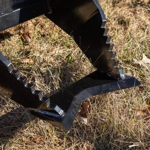 Tree Grubber Attachment front view mounted on skid steer
Close-up of cutting edge removing root
Attachment digging under tree taproot
Brush and root removal tool in action