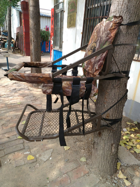 Closed-front hunting deer tree stand with Mossy Oak camo finish
Portable lightweight climbing tree stand for bowhunting
Steel frame deer stand setup on a tree outdoors
Deer stand footrest and seat dimensions close-up
Tree stand frame showing foldable design for easy transport