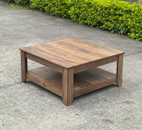 Rustic knotty oak coffee table in a farmhouse-style living room
Side view showing woodgrain texture and lower shelf
Top-down view of the square table surface
Decorated coffee table with books and storage baskets
Compact rustic wood table styled with cozy furniture